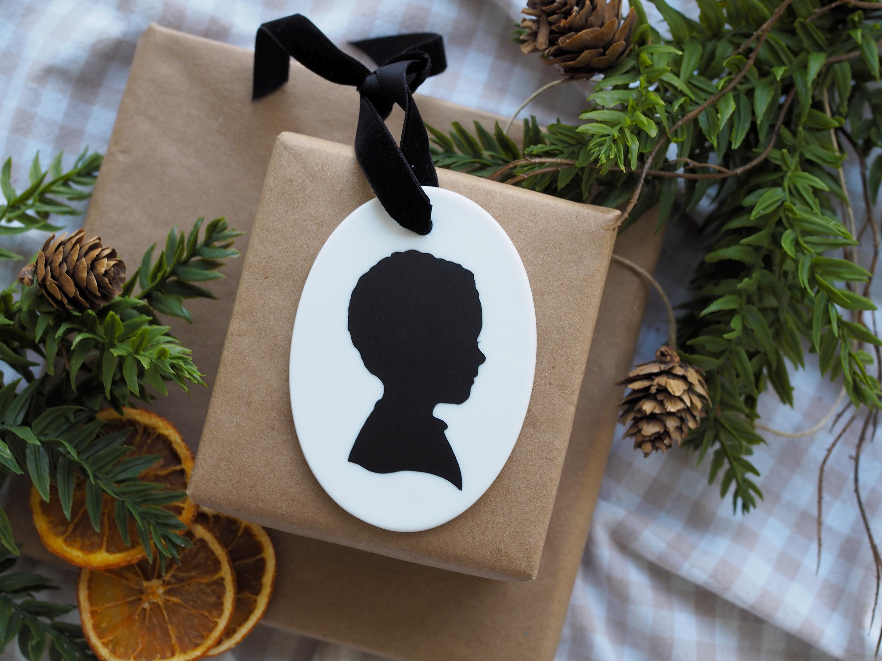 Personalized White Ceramic Oval Christmas Ornament with Hand-Cut Child Silhouette 2 - MeasureMason Personalized White Ceramic Oval Christmas Ornament with Hand-Cut Child Silhouette 2