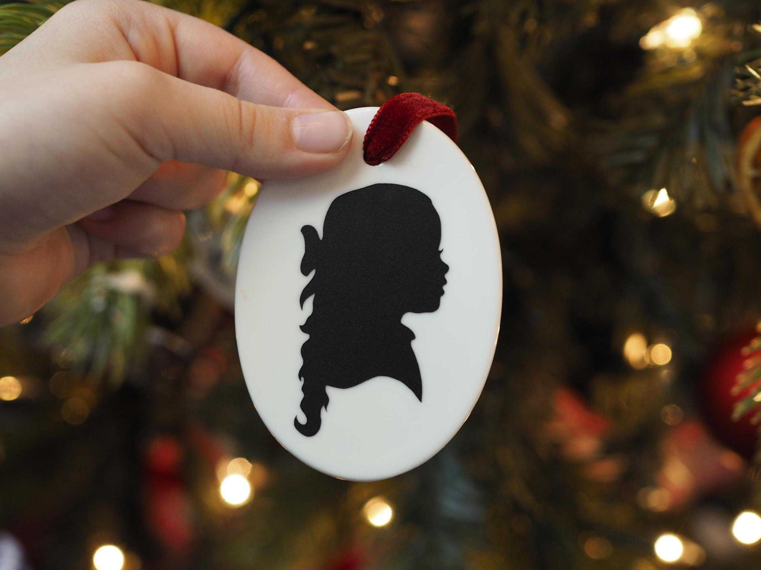 Personalized White Ceramic Oval Christmas Ornament with Hand-Cut Child Silhouette 3 - MeasureMason Personalized White Ceramic Oval Christmas Ornament with Hand-Cut Child Silhouette 3
